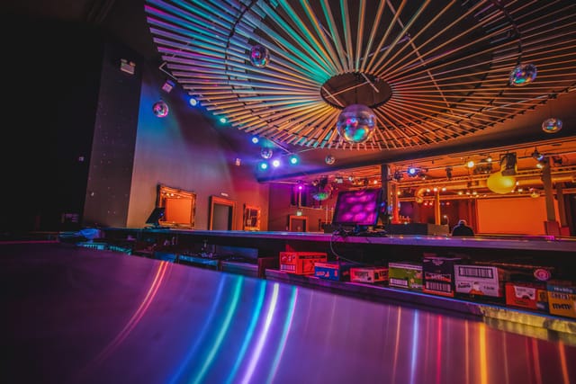 Vibrant Roller Nation event space with disco ball, ideal for parties and corporate events.