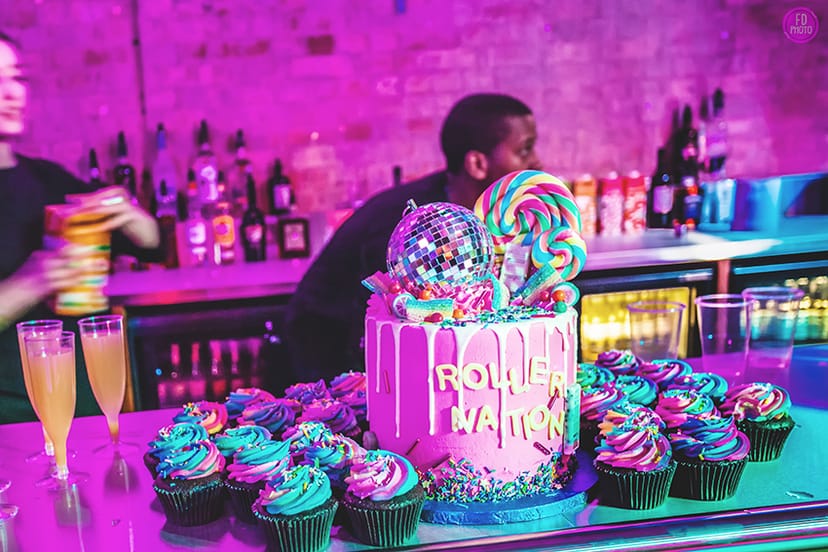 Vibrant event setup at Roller Nation with colorful cake for fun-themed parties.