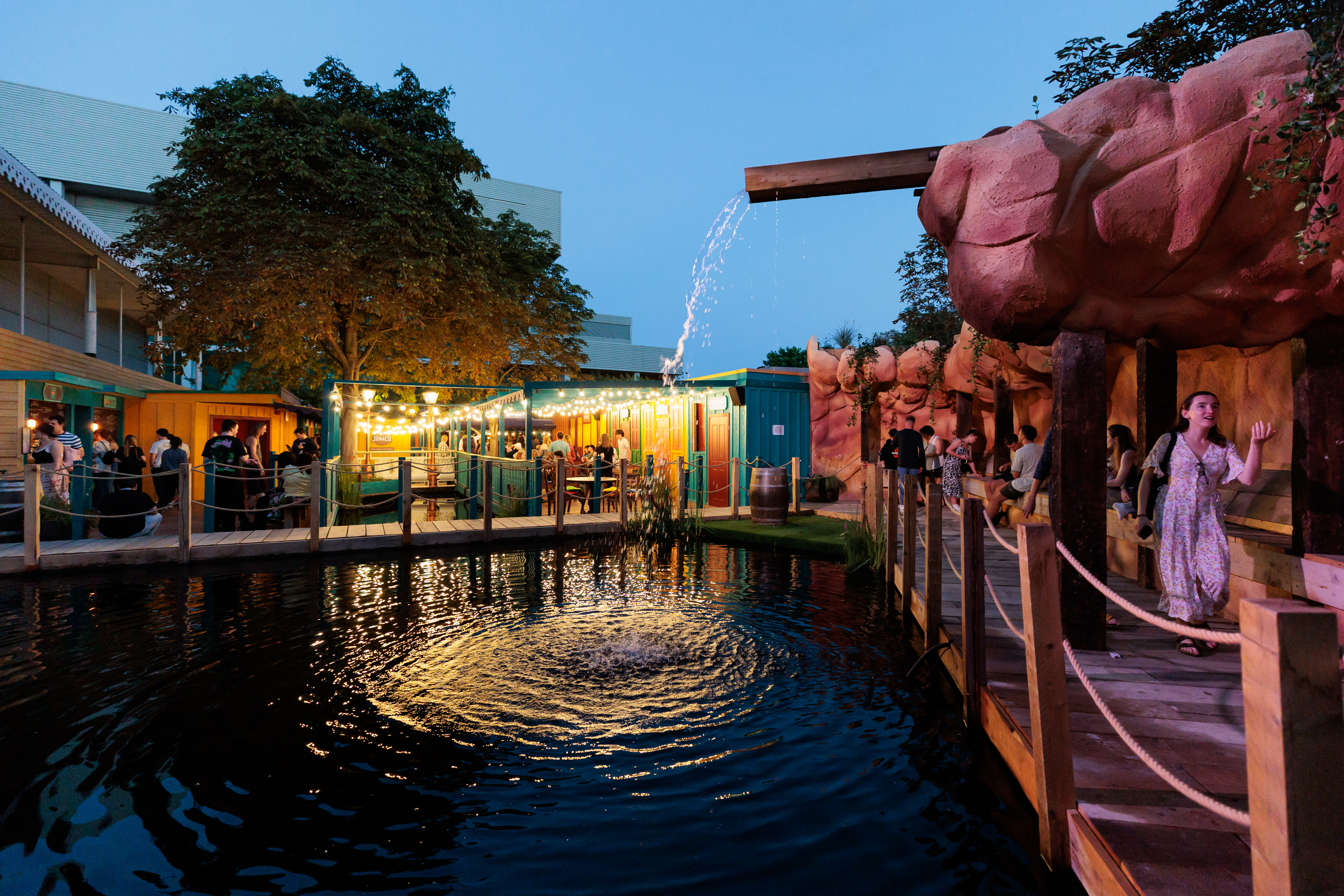 Vibrant outdoor event space at Phantom Peak with scenic water feature for gatherings. - Banner