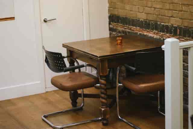 Cozy private dining room with rustic table, perfect for intimate meetings and brainstorming.