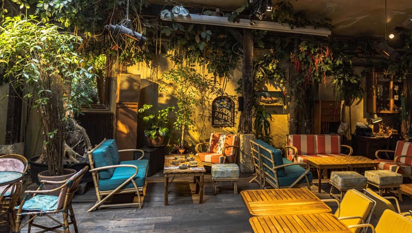 Cozy lounge with lush greenery for networking events at Comptoir General Aquarium Room.