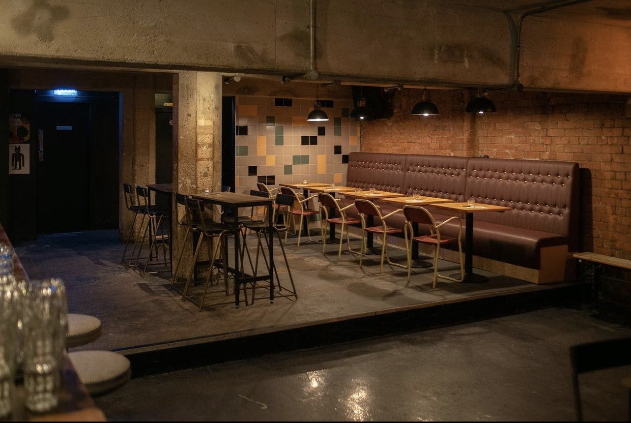 Versatile event space with exposed brick, ideal for networking and creative workshops.