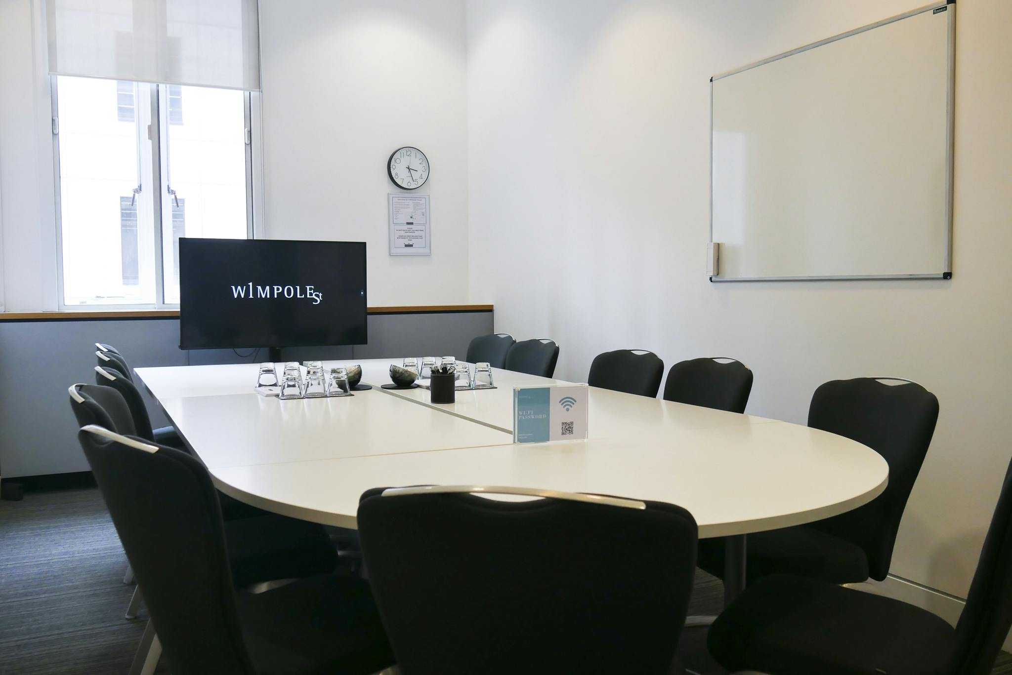 Modern Library Boardroom with oval table, ideal for meetings and presentations.