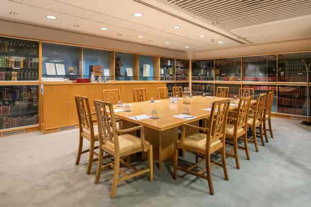 Heritage Centre meeting room with wooden table, ideal for intimate gatherings and board meetings.