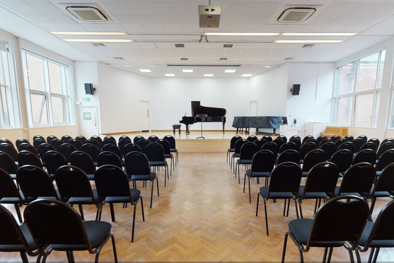 Recital Hall at Royal College of Music with pianos, ideal for concerts and workshops.