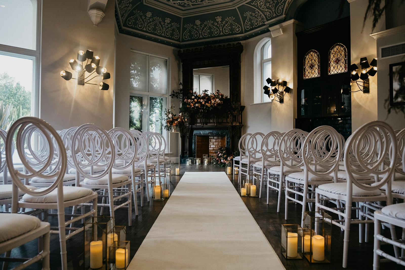 Elegant wedding setup at The Galloping Major with white chairs and romantic candlelight.