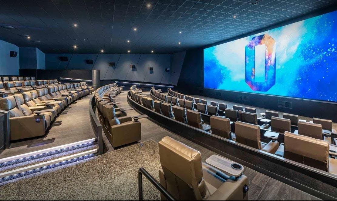 Upscale cinema venue with tiered seating for corporate events and presentations.