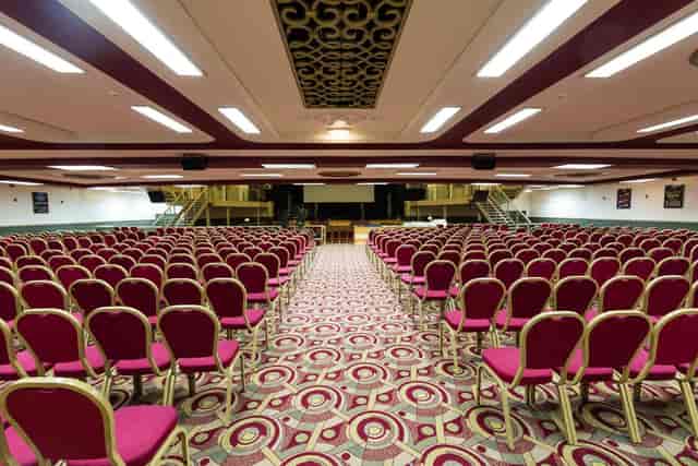 Spacious Lighthouse Venue with red chairs, perfect for conferences and presentations.