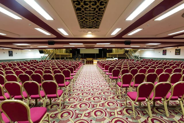 Spacious Lighthouse Venue with red chairs, perfect for conferences and presentations.