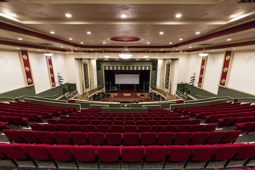 Lighthouse Venue auditorium with tiered red seating for conferences and performances.
