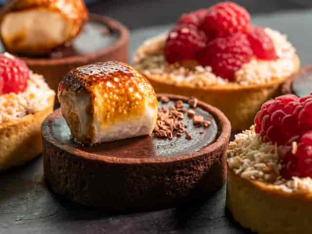 Gourmet chocolate tarts with meringue at Concorde Conference Centre event.