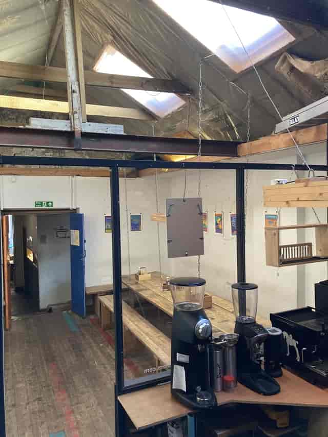 "Vagabond Coffee meeting space with rustic wooden tables for workshops and brainstorming."
