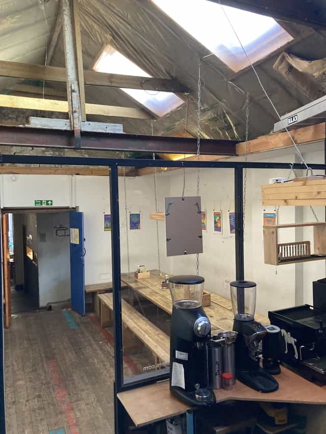 "Vagabond Coffee meeting space with rustic wooden tables for workshops and brainstorming."