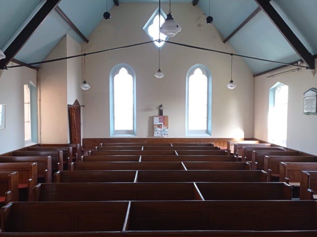 Ebenezer Chapel interior with wooden pews, ideal for community events and gatherings.