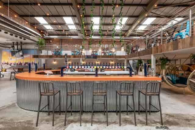 Modern Fourpure Taproom with sleek bar, ideal for networking events and gatherings.