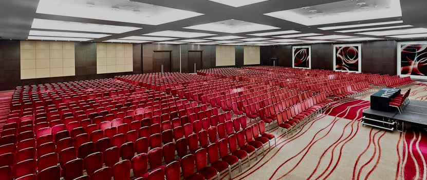Westminster Ballroom with red chairs, ideal for corporate conferences in London.