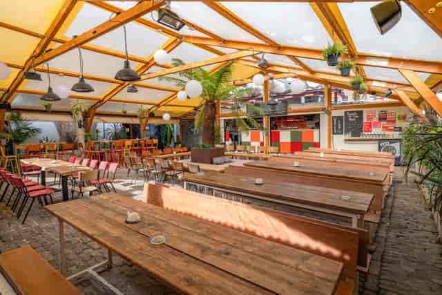 Peckham Arches venue for corporate mixers and group dining with rustic bench seating.