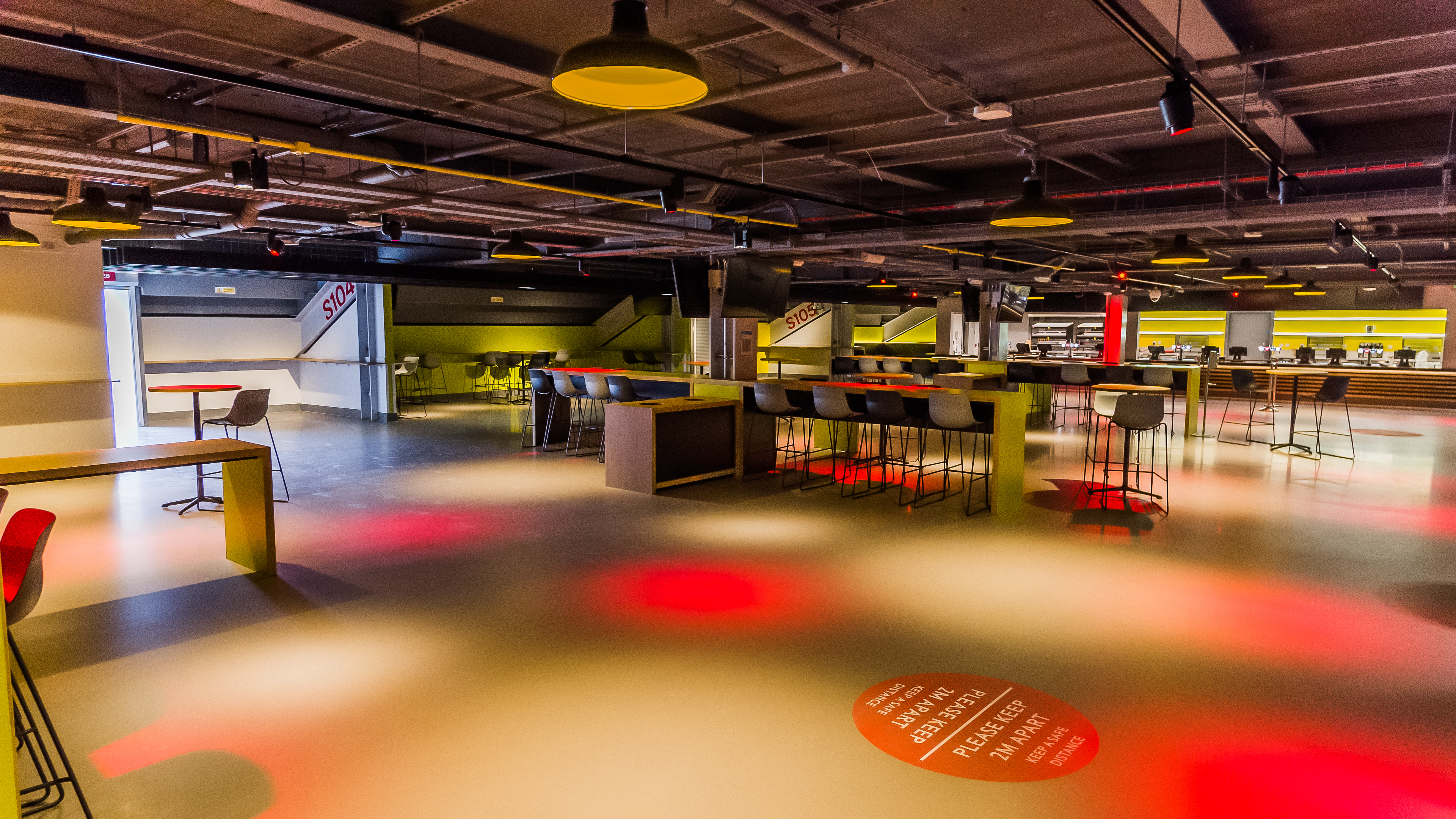 Modern event space at Brentford FC with flexible seating for networking and workshops. - Banner