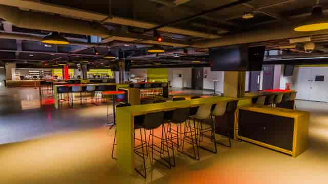 Modern event space at Brentford FC with high-top tables, ideal for networking and gatherings.