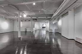 Spacious event venue with polished floors, ideal for exhibitions and networking.