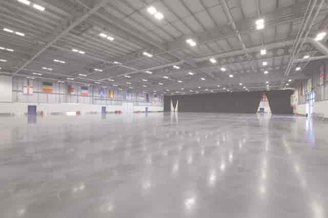 Spacious East of England Arena event hall with polished concrete floor for trade shows.
