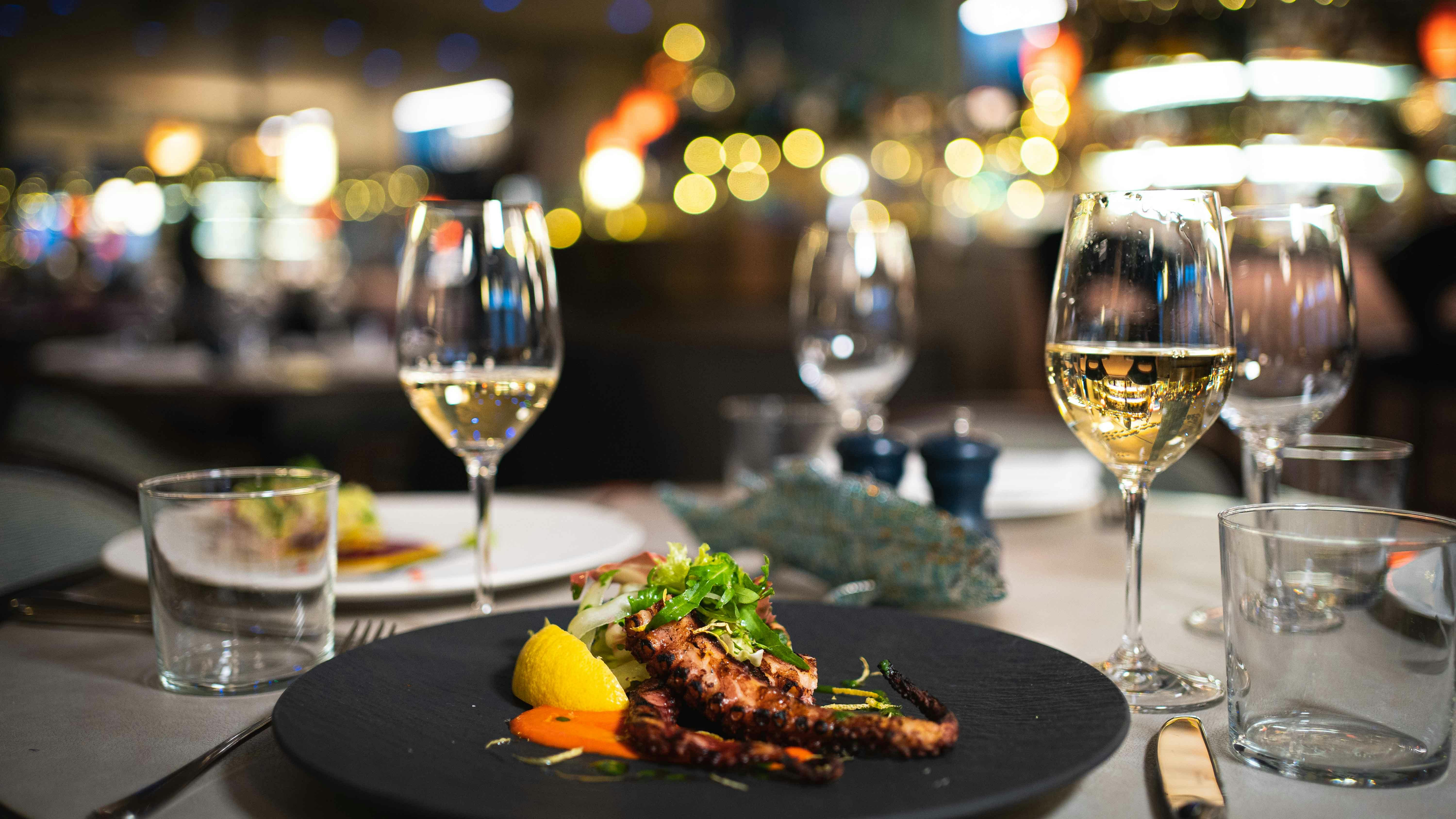 Elegant dining table with grilled octopus at Casa Matilde for upscale events and galas.