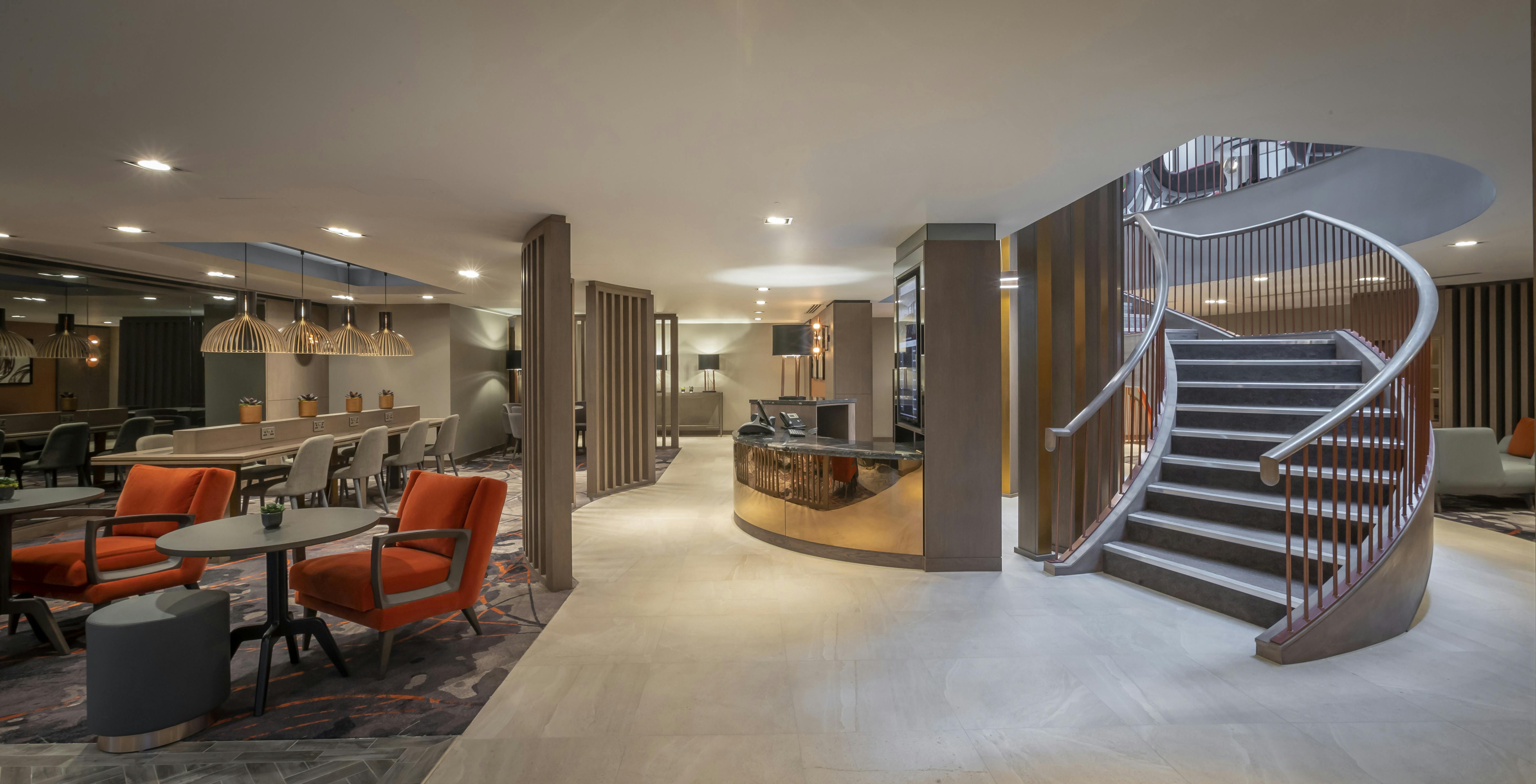 Modern lobby at Clayton Hotel Bristol, ideal for meetings and events with elegant staircase.