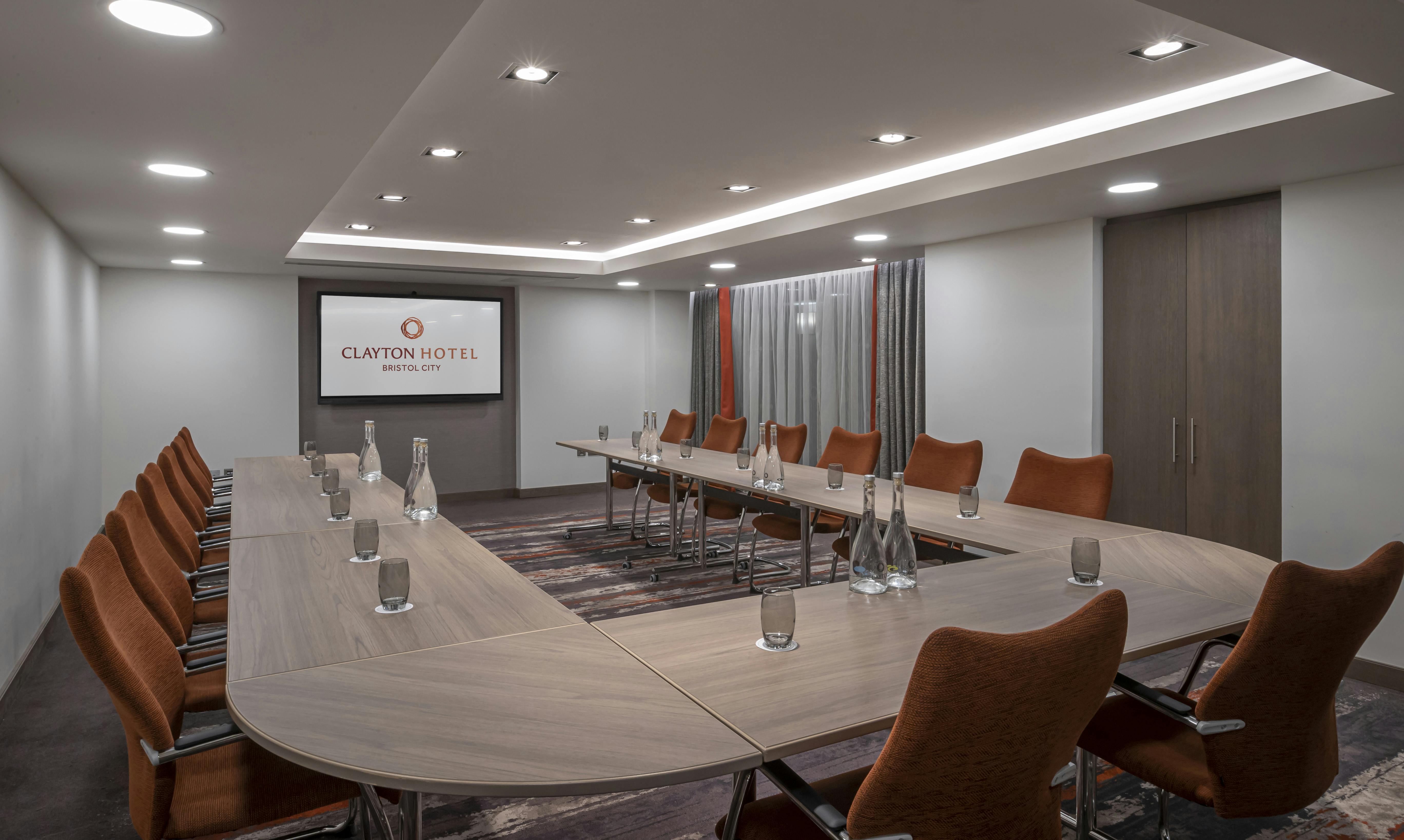 Modern meeting room at Clayton Hotel Bristol with oval table, ideal for corporate events.