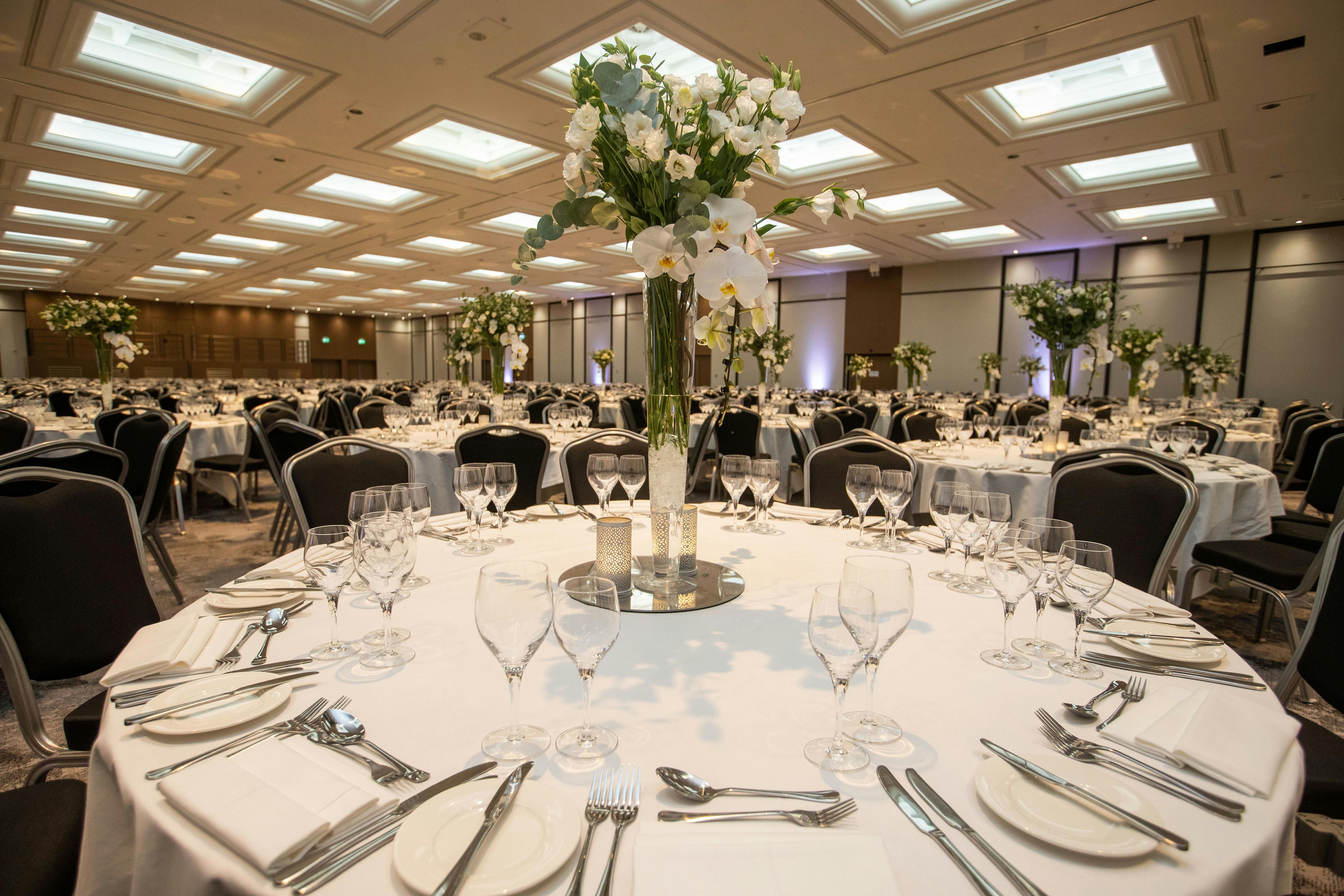 Richmond Suite banquet hall at Hilton London Metropole, elegant floral centerpieces for events.