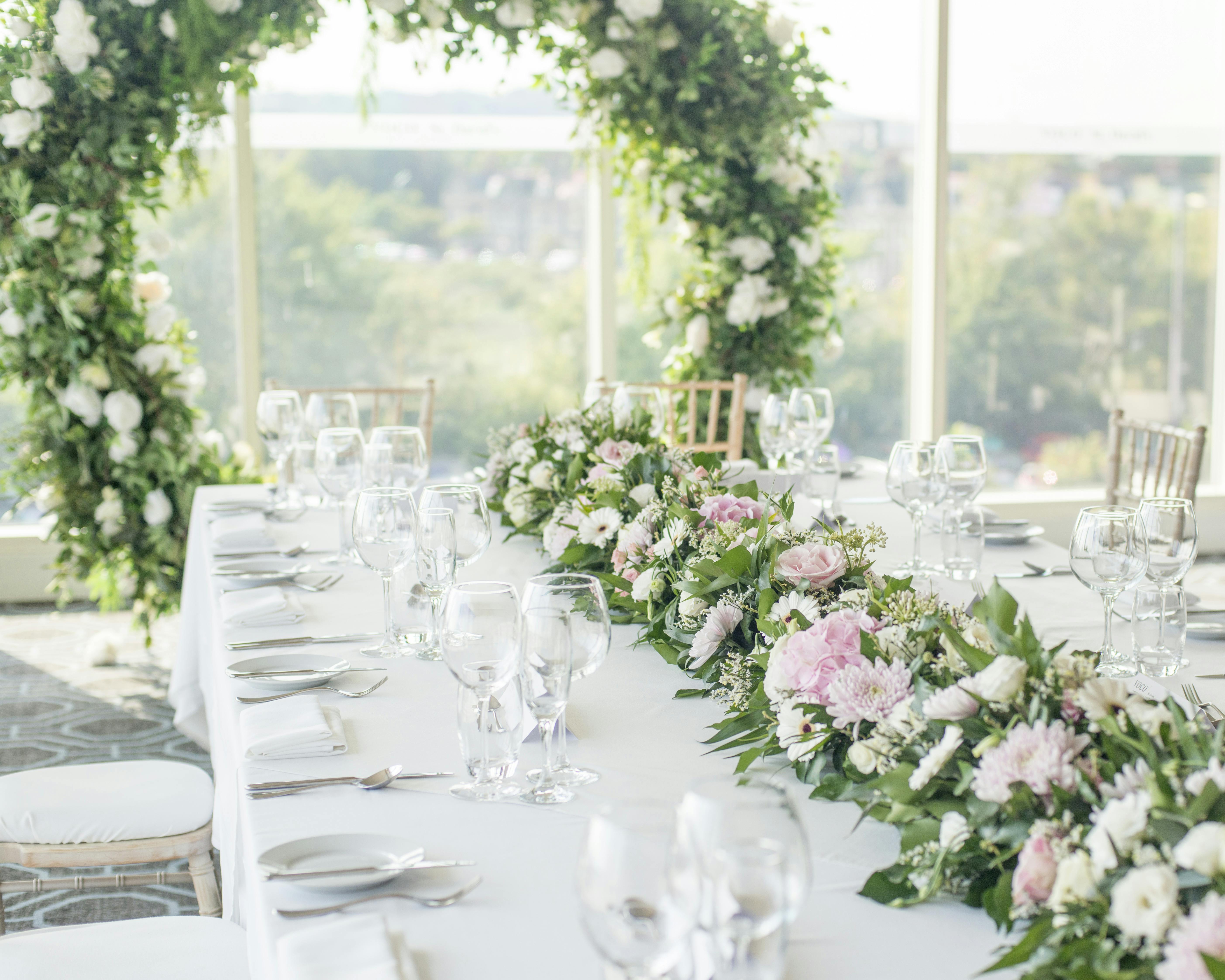 Elegant banquet table with floral arrangements at Voco St David's Cardiff for weddings.