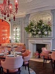 Elegant event space at THE VAULT, featuring a vibrant orange door and plush seating.