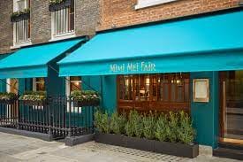 Stylish venue THE VAULT with turquoise awnings, perfect for events and gatherings.