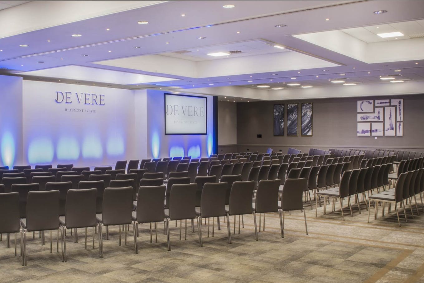 Event space at De Vere Beaumont Estate with chairs for a professional conference.