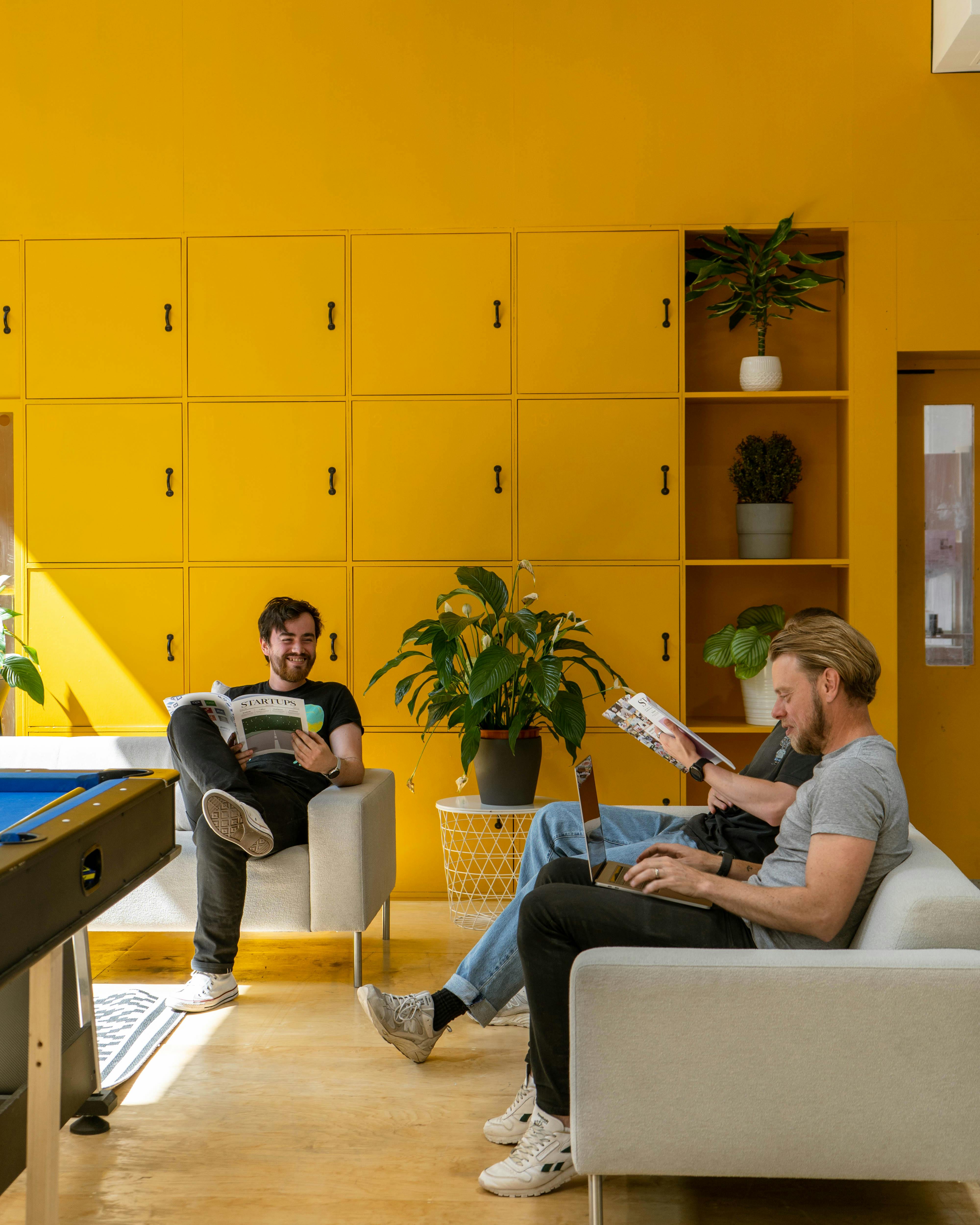 Event space with yellow backdrop for casual meetings and brainstorming sessions.
