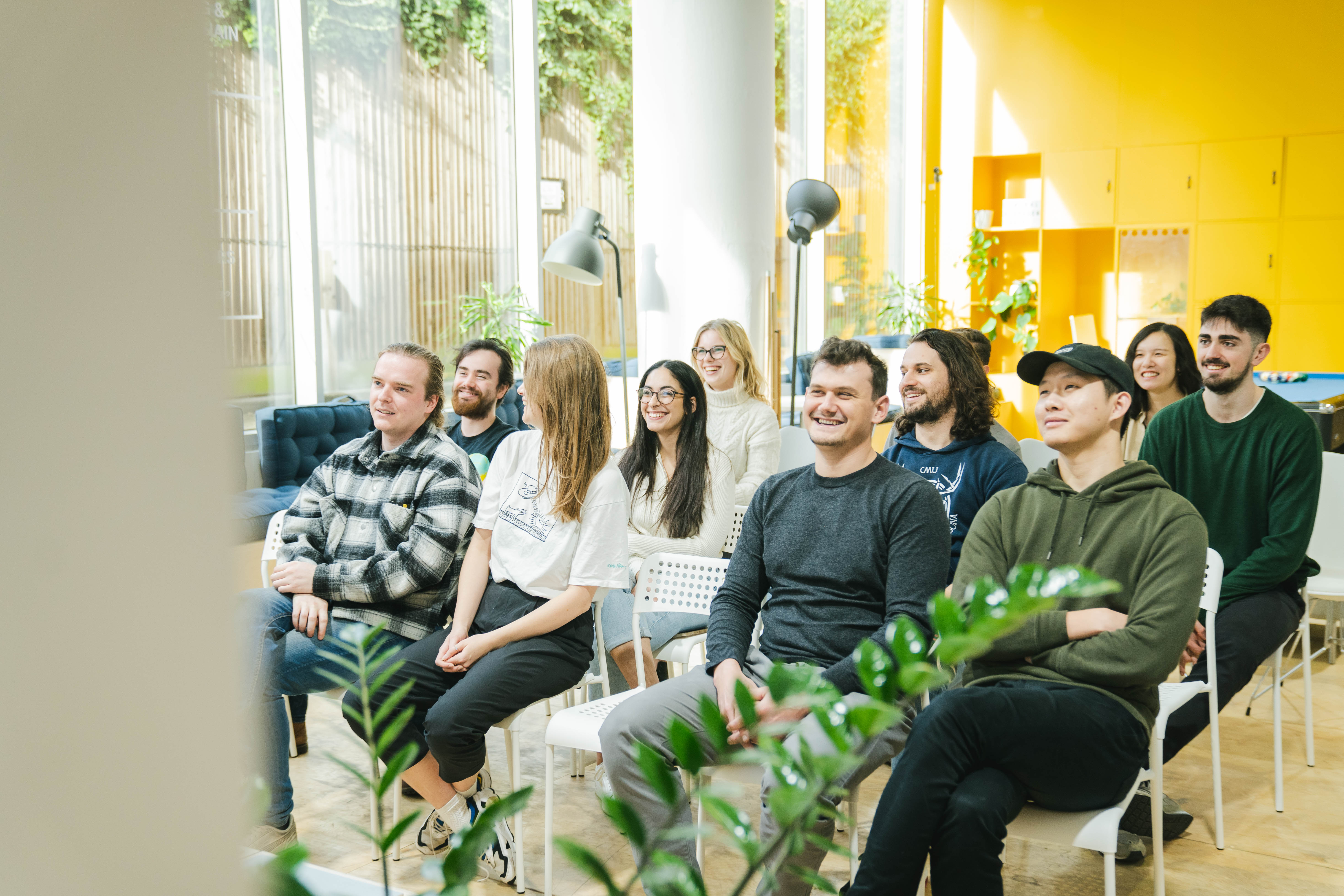 Diverse attendees in a bright event space fostering collaboration and creativity. - Banner