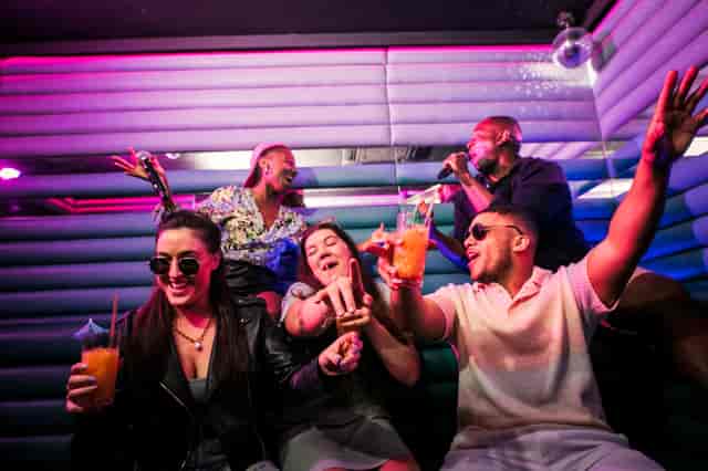 Vibrant social event at Lucky Voice Holborn with colorful lighting and engaged participants.