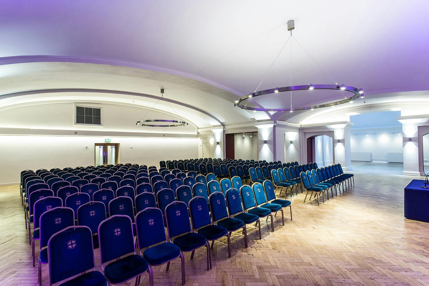 Aldersgate venue in Central Hall Westminster, featuring blue chairs for conferences and seminars.