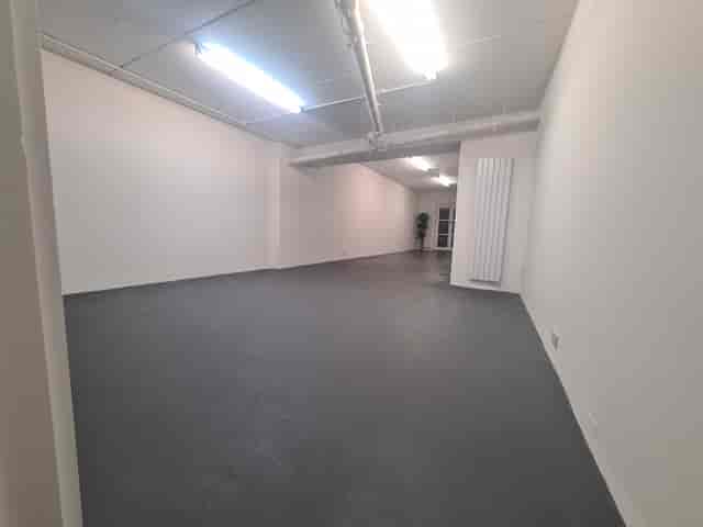 Spacious B. T. Batsford Gallery venue with polished floor for events and workshops.