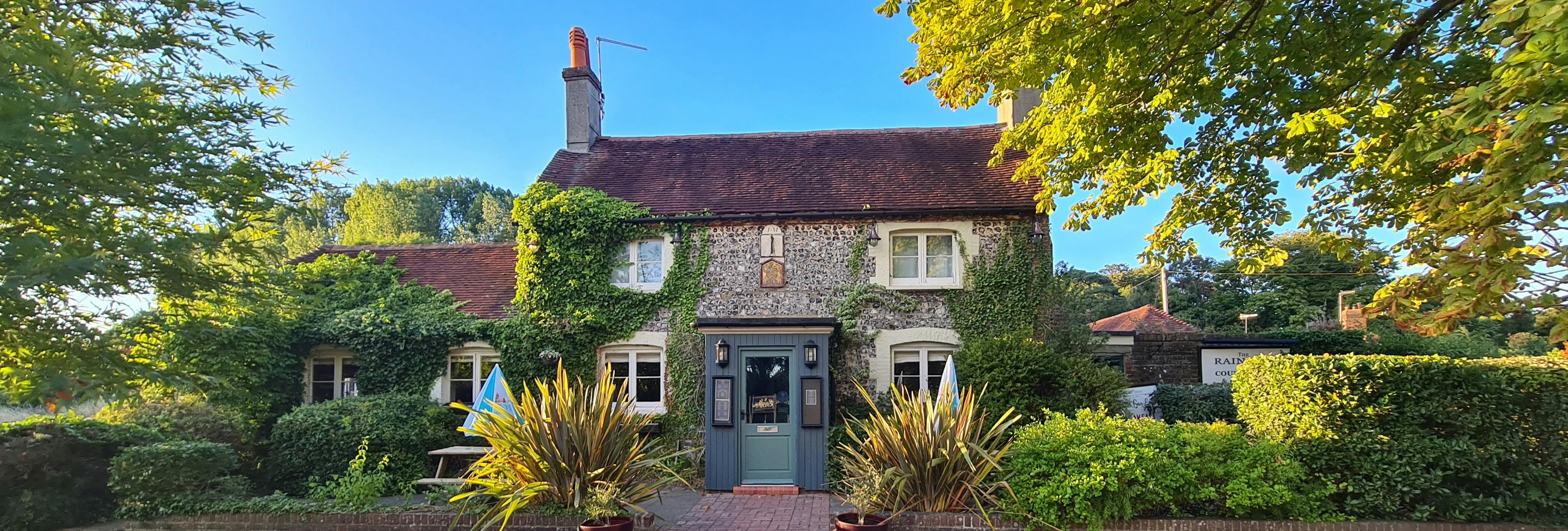 Charming Rainbow Inn venue with rustic exterior for intimate gatherings and retreats.