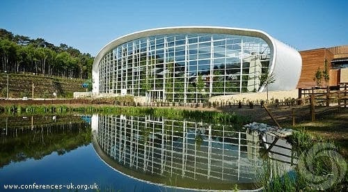 Modern conference room with glass facade at Centre Parcs Woburn, ideal for serene events.