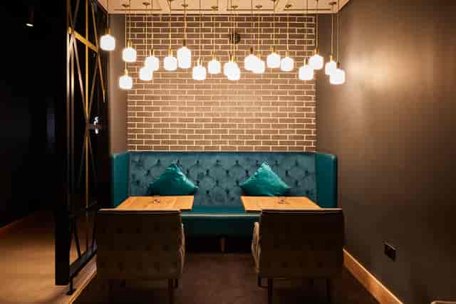 Cozy teal booth in ODEON Luxe Islington, ideal for networking events and meetings.