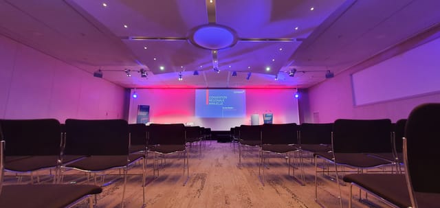 Conference room in Grands Causses, Aveyron with sleek chairs and ambient lighting.