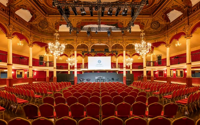 Elegant event space with chandeliers, ideal for conferences and gatherings.