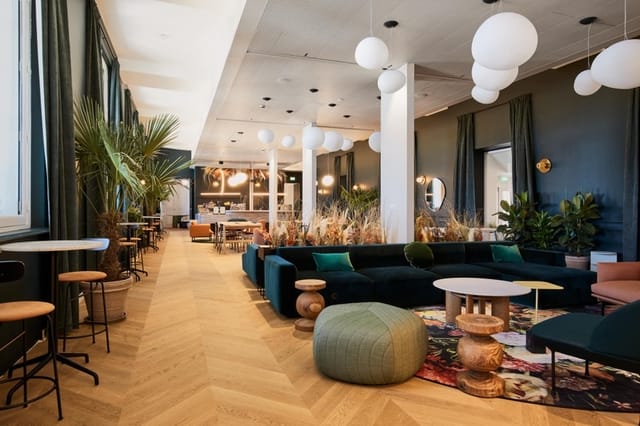 Modern event space with cozy seating and vibrant decor for meetings and networking.