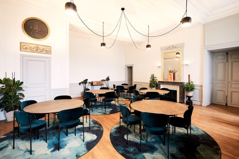 Stylish meeting room with circular tables, ideal for networking events and workshops.