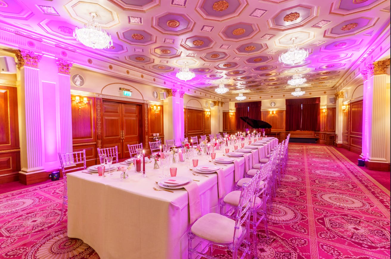 Elegant banquet room in Livery Hall with pink accents, ideal for upscale events and gatherings.