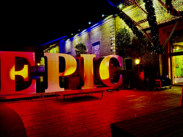 Vibrant EPIC event space with illuminated letters, ideal for networking and celebrations.