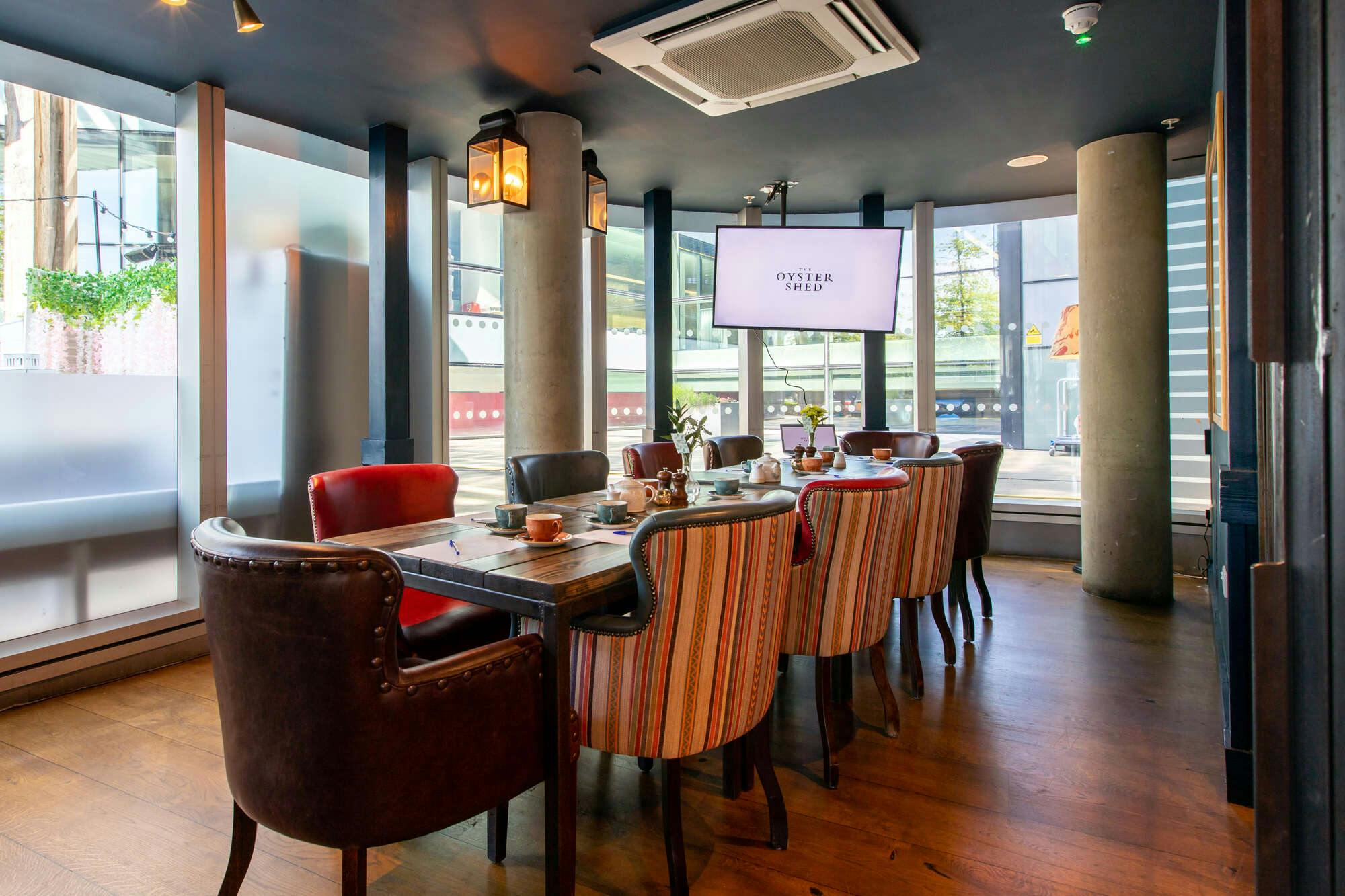 Stylish meeting room with long table for intimate gatherings at The Cabin in The Oyster Shed.