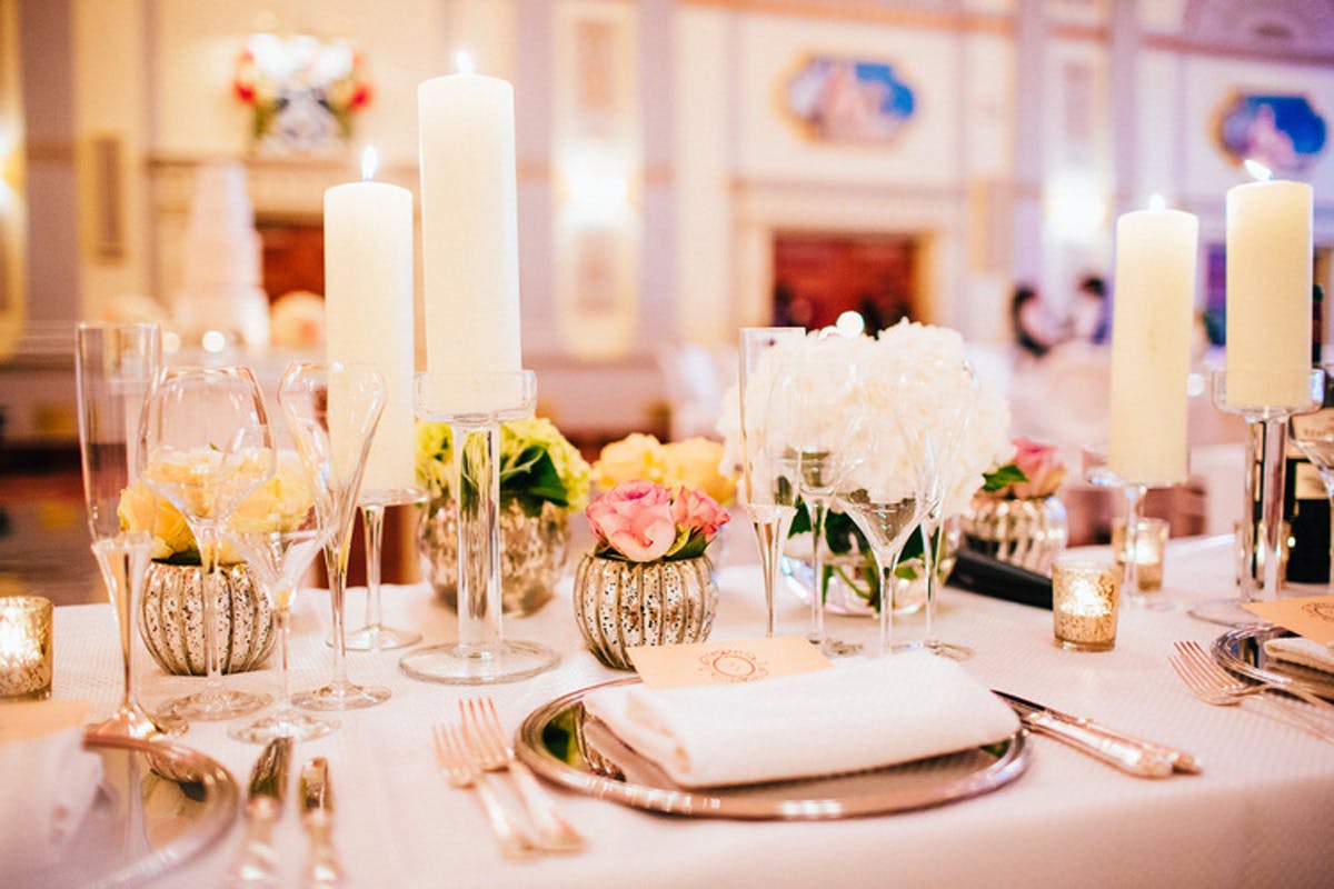 Elegant table setting with candles and flowers in Mott Room, perfect for weddings or events.