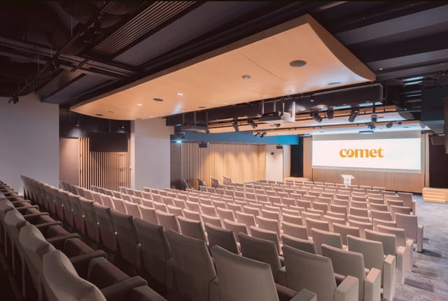 Modern conference room with tiered seating for corporate meetings and seminars.